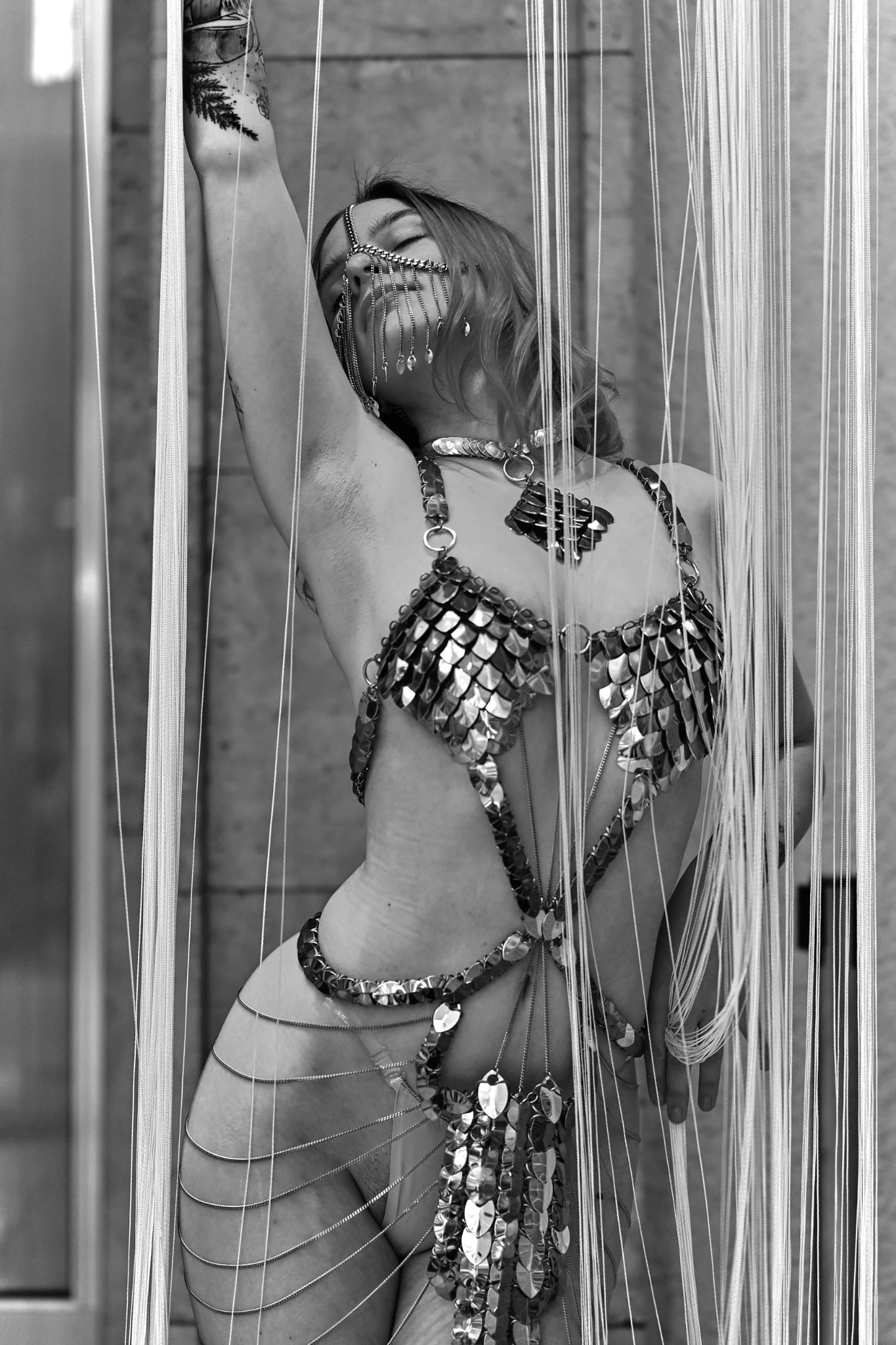 metallic scale bikini with chains, avant-garde fashion style, expressive and sensual pose