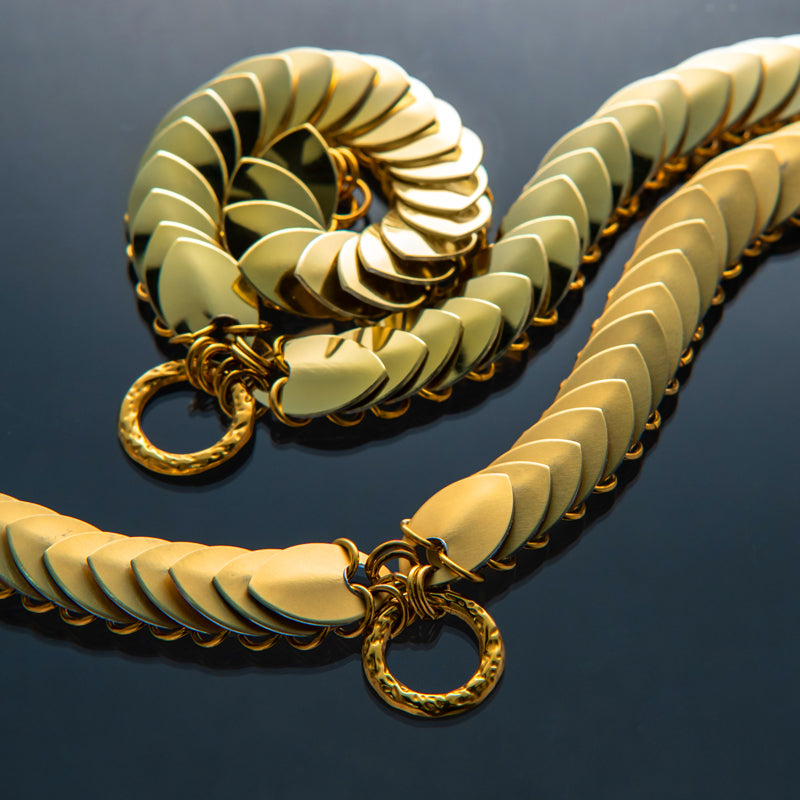 Gold chain necklace with smooth, overlapping links in a modern style evoking luxury and elegance